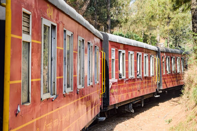 Kalka shimla toy train moving on mountain slope, beautiful view, one side mountain, one side valley