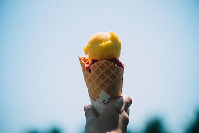 Close-up of hand holding ice cream