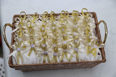 Close-up of white flowers in basket on table