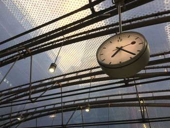 Low angle view of clock hanging from ceiling in building