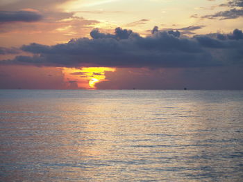 Scenic view of sea against romantic sky at sunset