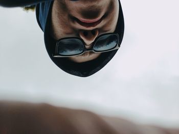 Close-up portrait of young man against sky