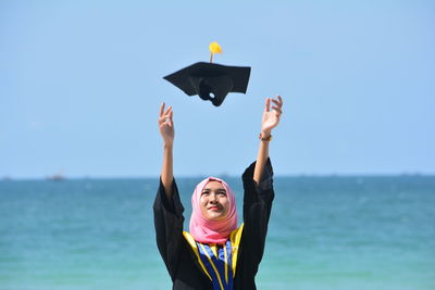 Happy woman standing against clear sky