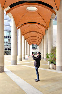 Full length rear view of man walking in building