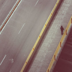 High angle view of a man walking on road