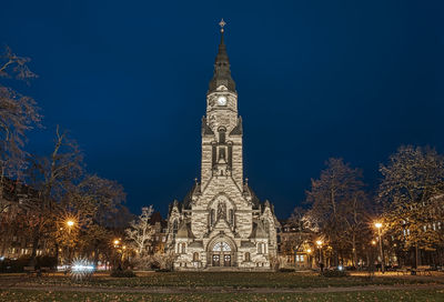 Illuminated building against sky at night