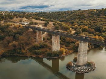 Bridge over river against sky