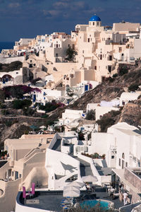 High angle view of town by sea against sky