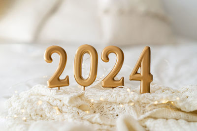 Happy new years 2024. christmas background with 2024 candles and white knit sweater.