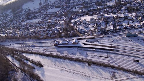 High angle view of snow covered road by city