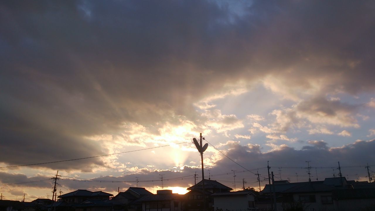 sunset, silhouette, sky, power line, building exterior, built structure, electricity pylon, cloud - sky, architecture, low angle view, electricity, sun, power supply, cloudy, cloud, street light, cable, sunlight, fuel and power generation, connection