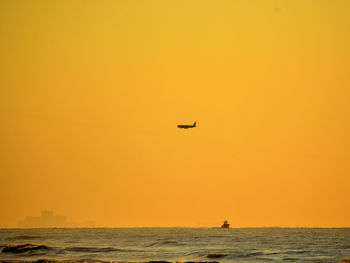 Scenic view of sea against clear sky during sunset