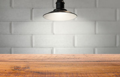 Close-up of illuminated lamp on wall at home