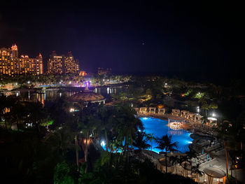 High angle view of city lit up at night