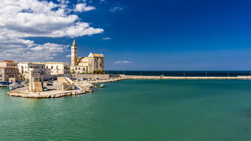 View of building by sea against sky