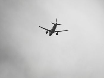 Low angle view of airplane against sky