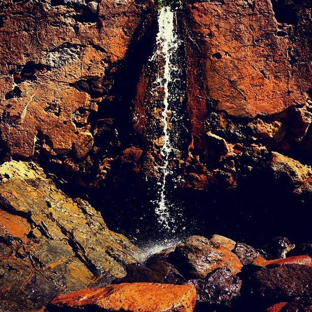 rock - object, rock formation, textured, rock, rough, nature, high angle view, close-up, geology, water, outdoors, day, rocky, no people, sunlight, beauty in nature, stone - object, natural pattern, stone, eroded