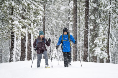 Panoramic view of people on snow covered land