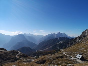 Scenic view of mountains against blue sky