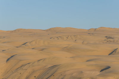Scenic view of desert against clear sky