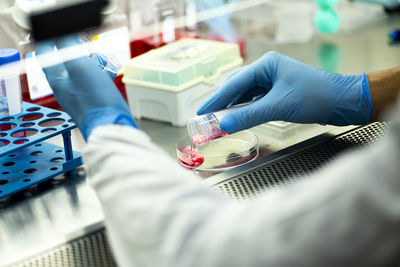 Midsection of doctor examining patient in laboratory