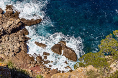 High angle view of rocks at sea shore