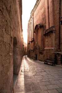 View of old alley amidst buildings in city