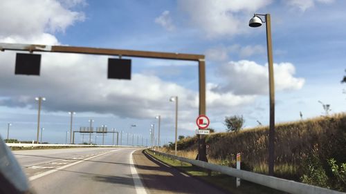 Road sign against sky