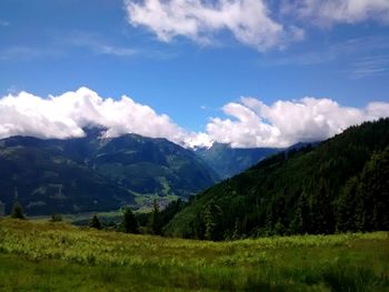 Scenic view of mountains against cloudy sky