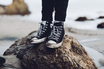 Low section of person standing on rock