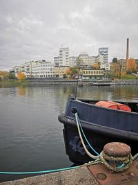 Bridge over river against buildings in city