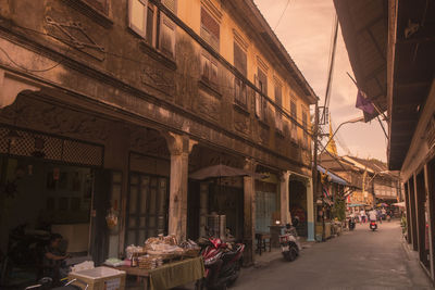 People on street amidst buildings in city
