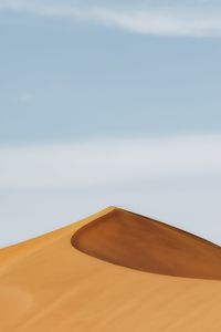 Sand dunes against sky