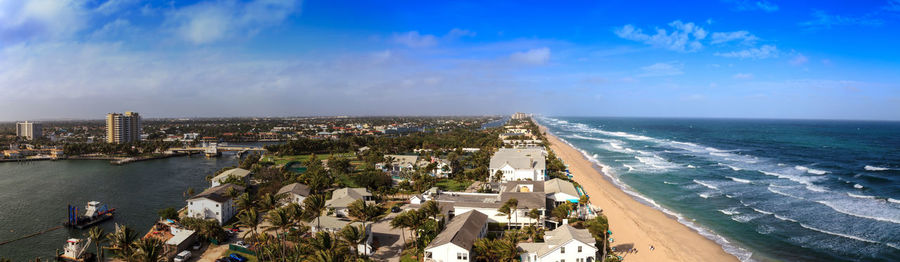 High angle view of buildings and sea against sky