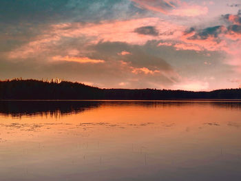 Scenic view of lake against orange sky