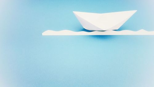 Close-up of white paper against blue background