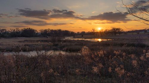 Scenic view of lake against sky during sunset