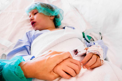 High angle view of boy lying on bed