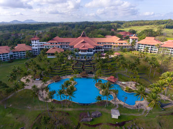 High angle view of swimming pool by buildings against sky