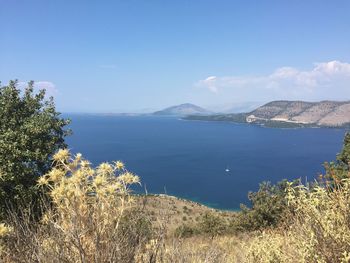 Scenic view of sea and mountains against sky