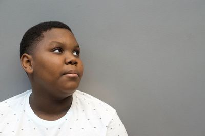 Portrait of teenage boy against wall