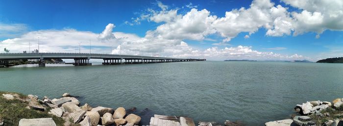 Panoramic view of bridge over sea against sky