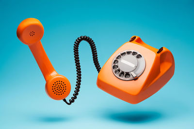 Close-up of telephone booth against blue background