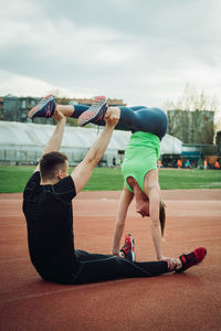 Young couple exercising on sports track