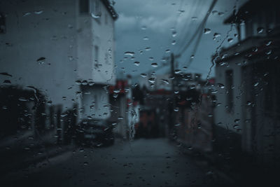 Full frame shot of wet glass window in rainy season