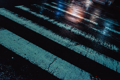 High angle view of wet crossing road at night
