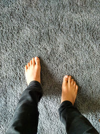 Low section of person standing on rug