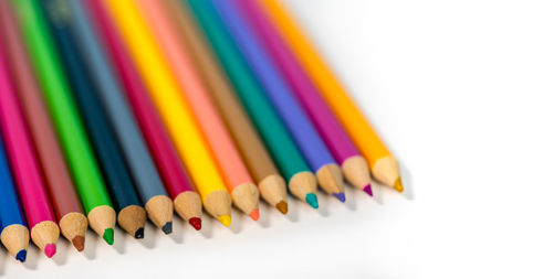 Close-up of colored pencils against white background