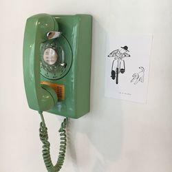 Close-up of rotary phone on wall