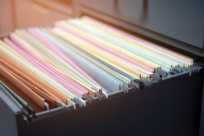 Close-up of multi colored envelopes in locker